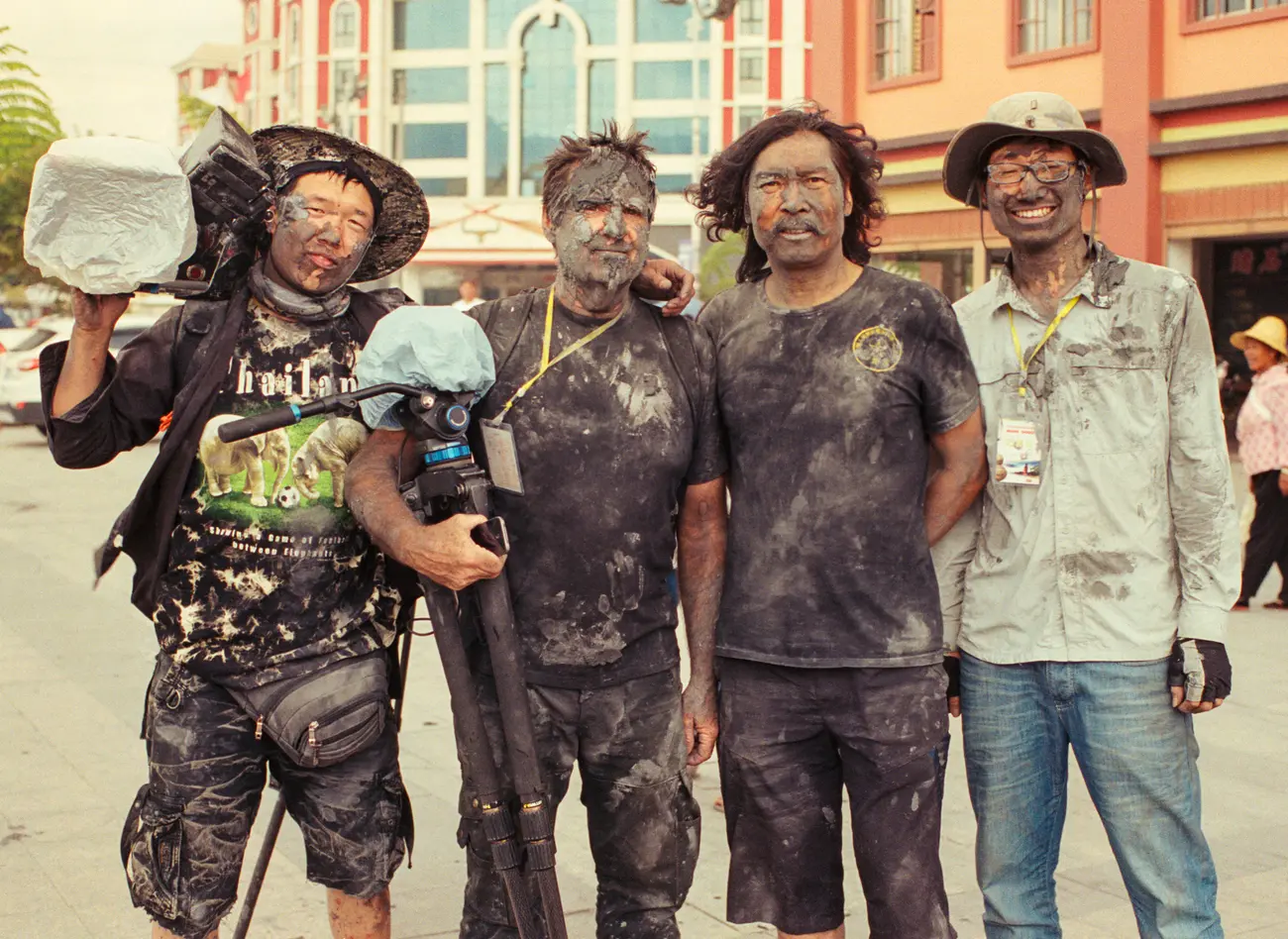 Camera assistant Gary Liu, DOP Mike Single, driver Chen Shan and field assistant Joshua Cheng in the aftermath of the Monihei Carnival in Yunnan