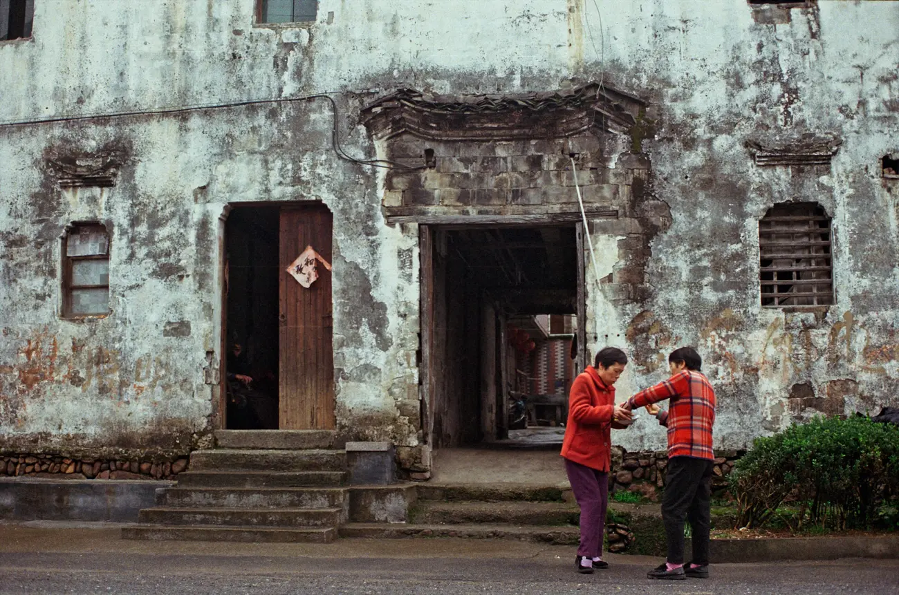 Two aunties share a breakfast on the Panzhoujia village main street.