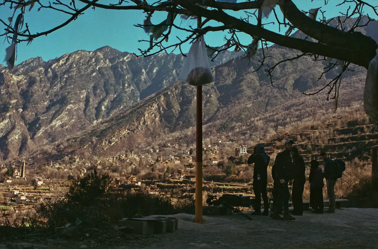 The crew plan a shot from the monastery overlooking the mountainside village of Zhonglu.