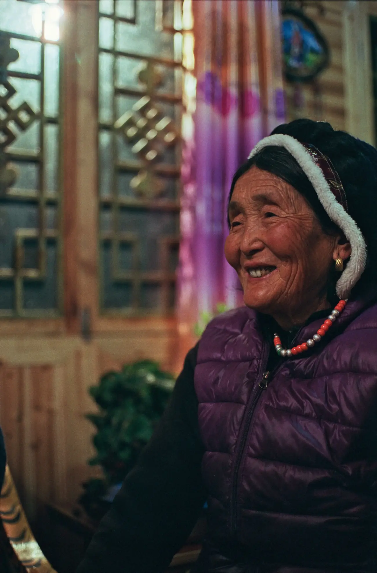 Grandma Xiage-achong enjoying dinner in her house.