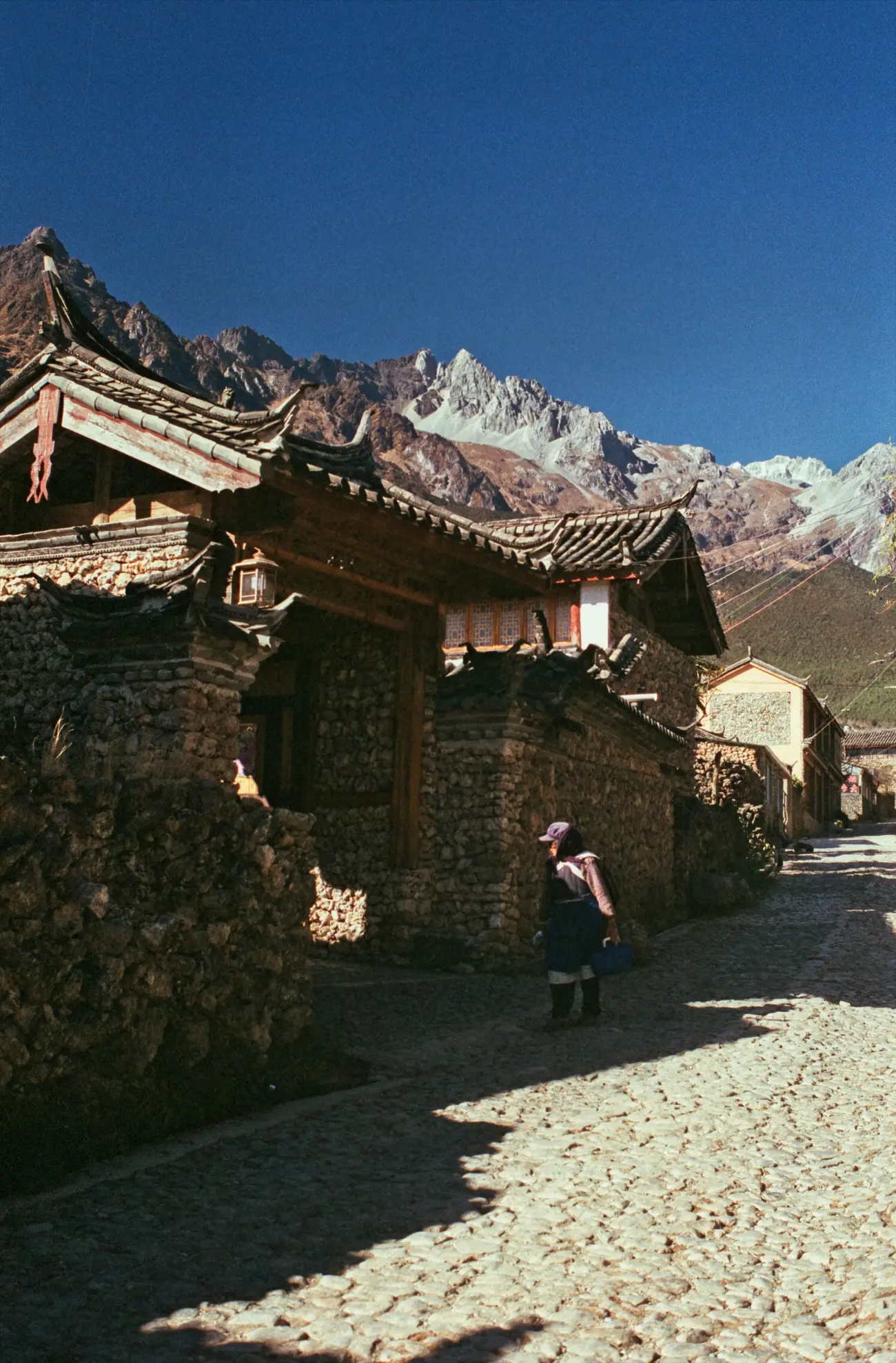 A local Naxi woman goes for a walk around Yuhu village.