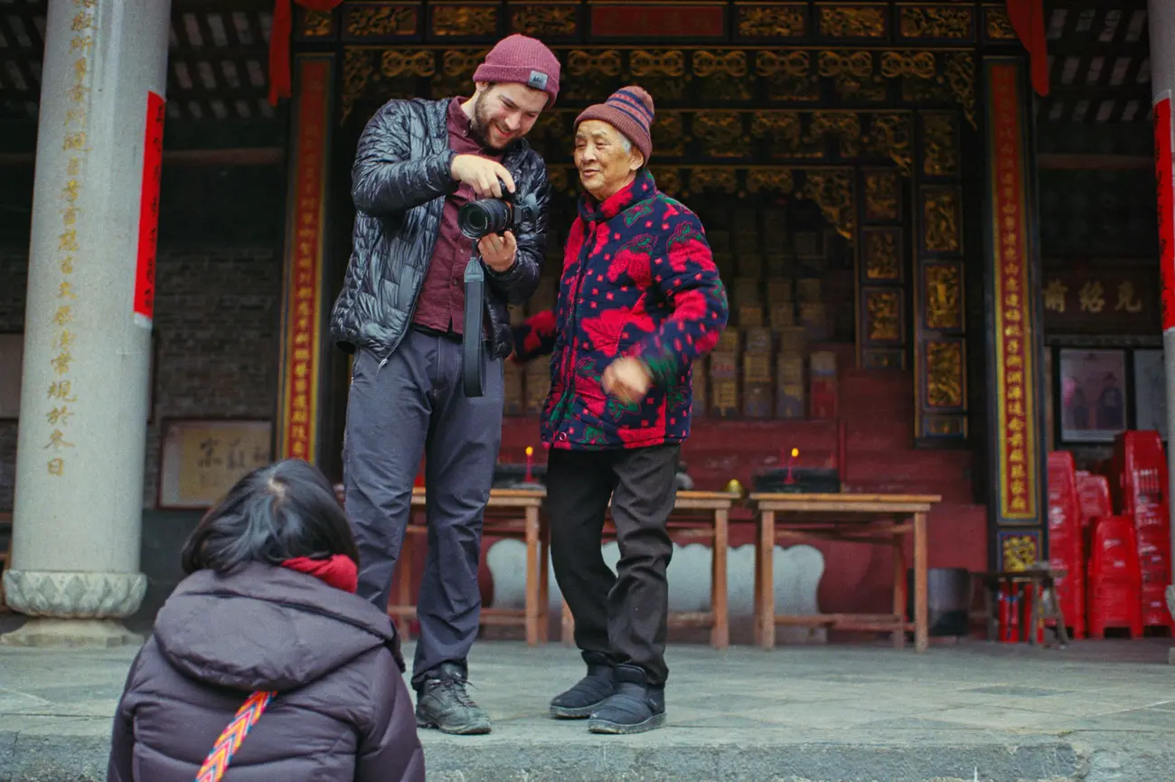 Our camera operator shows Guo-nainai what he's captured.